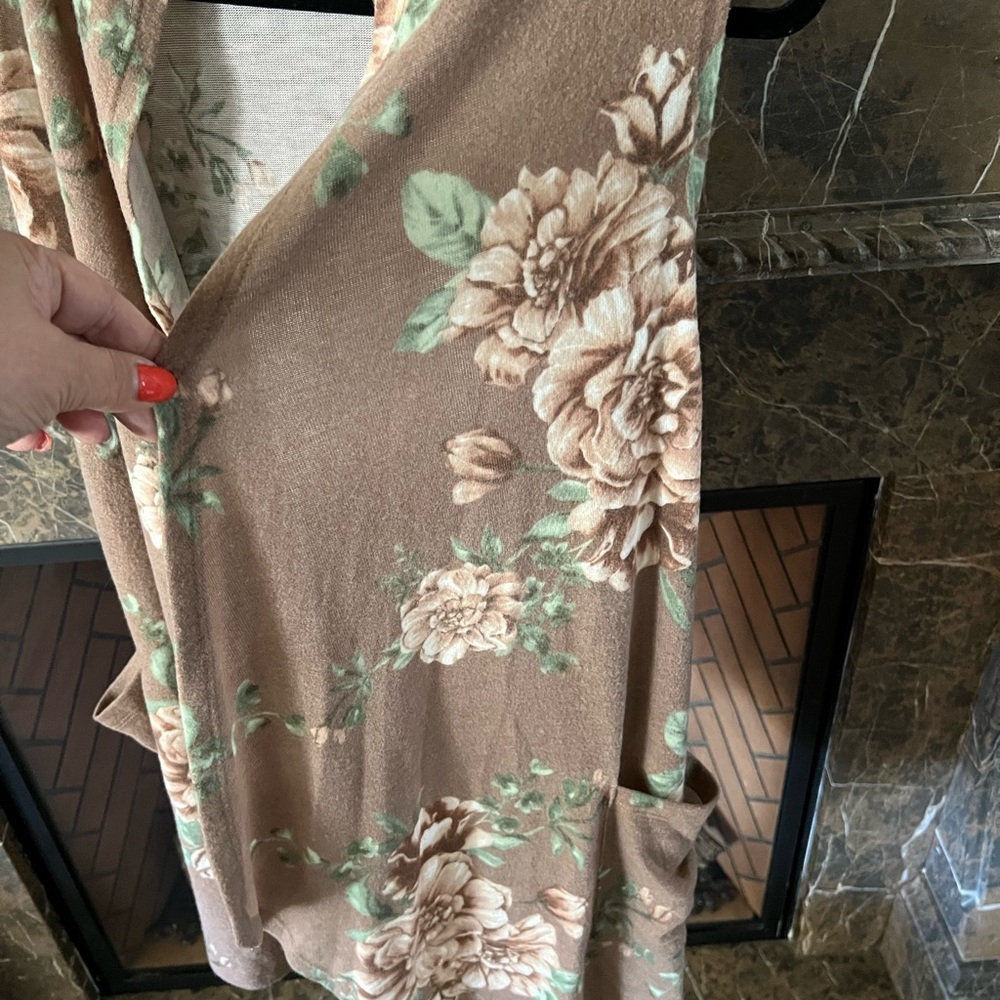 Floral vest. Pockets. Feels like puppy fur.  Never worn.  Fits up to a 2X